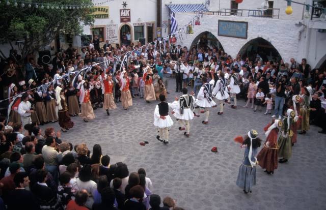 Greek folk dancers in a public square in Greece